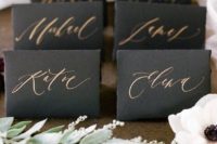 25 black place cards with copper calligraphy