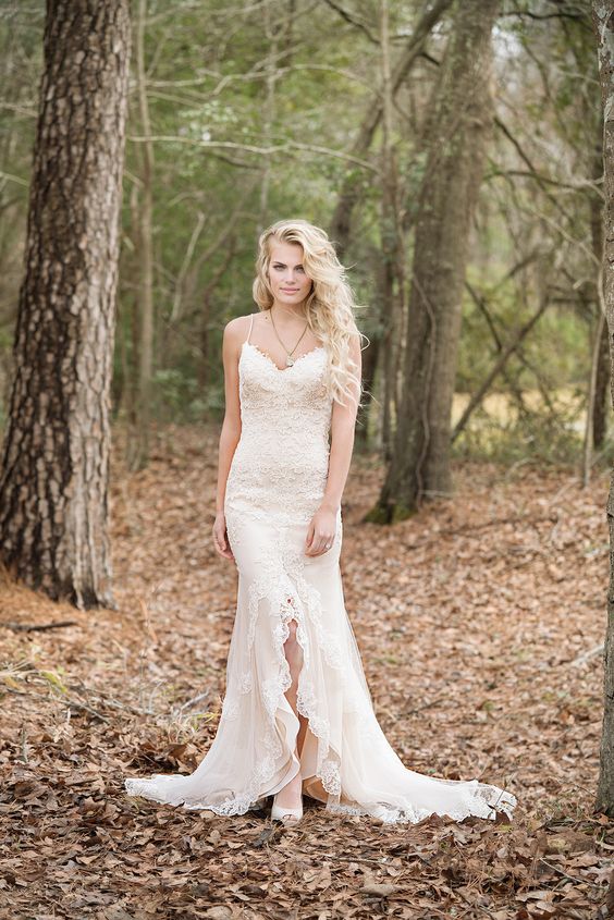 lace applique wedding dress with spaghetti straps and a center ruffled slit