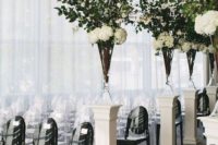 29 modern chic aisle decor with black chairs and textural greenery and flower compositions