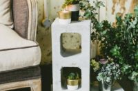 32 concrete stands with greenery and flowers for wedding decor