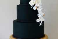 33 black wedding cake with white edible flowers