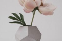 33 faceted concrete vase with a single large bloom