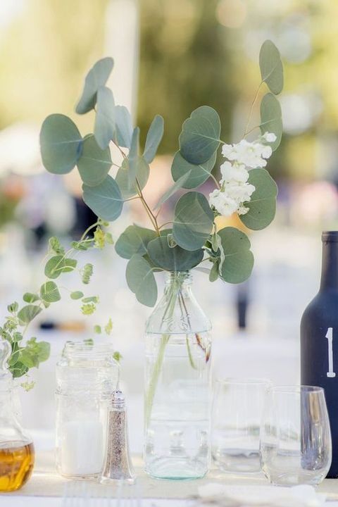 simple eucalyptus and flower centerpice in a sheer vase