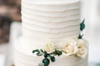 33 simple white cake decorated with greenery and neutral flowers