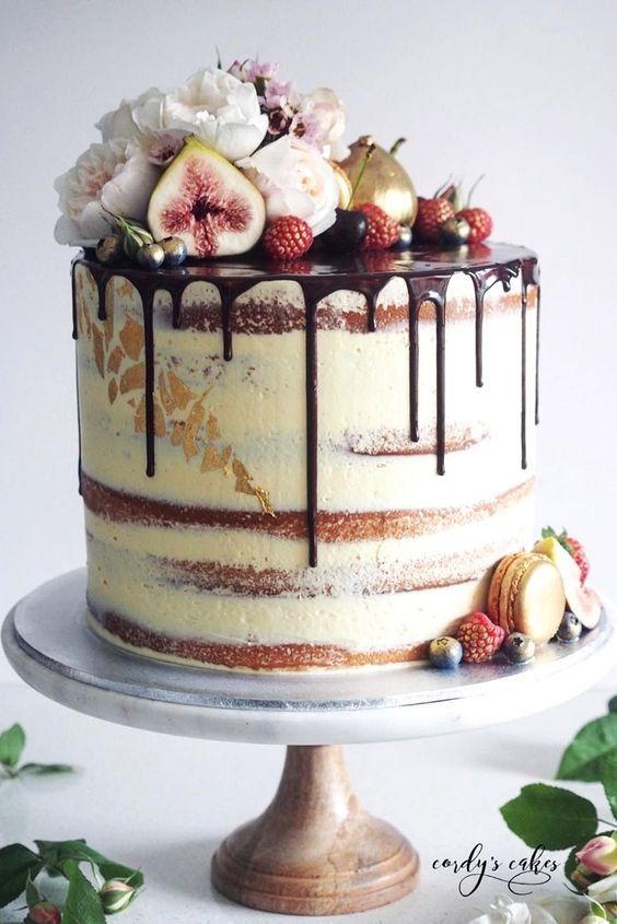 semi naked wedding cake with chocolate drip, berries and blooms