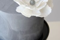 35 textural concrete wedding cake with a large white flower