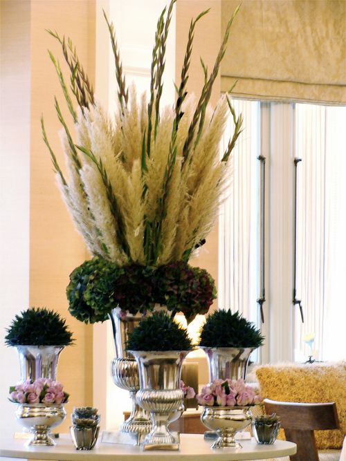 plumes of pampas grass with gladiolus in a tall vase