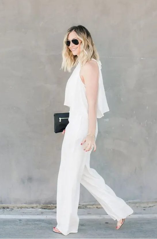 a chic and casual bridal shower outfit with a crop top and high waisted pants, nude shoes and a small black bag