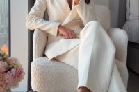 a chic and modern bridal shower look in a creamy pantsuit, with creamy shoes and a small woven bag