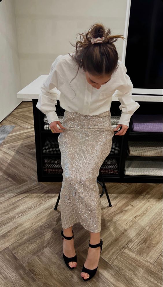 a classy pre-wedding party outfit with a white button down, a silver sequin maxi skirt, black shoes and a messy hairstyle
