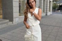a cool and chic look with a white waistcoat and wideleg pants, a small bag is a lovely and modern idea