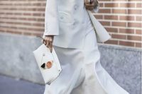 a white maxi dress, a white jacket, white boots and a clutch for an elegant bridal shower look