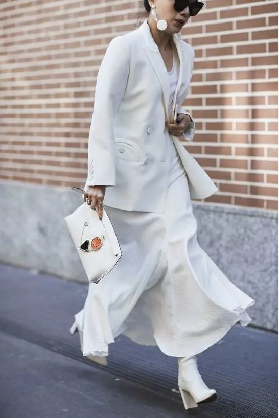 a white maxi dress, a white jacket, white boots and a clutch for an elegant bridal shower look