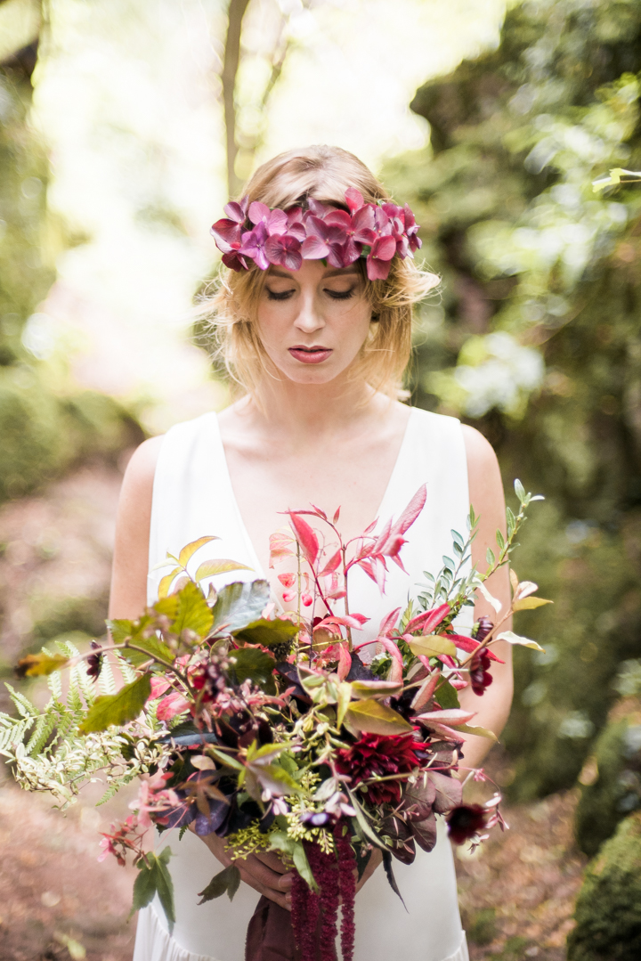 The bride was wearing a moody floral crown and a bouquet, and her dress was relaxed boho-chic