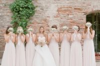 02 The bride was wearing a strapless dress with wrap skirt detailing and her bridesmaids were rocking blush gowns