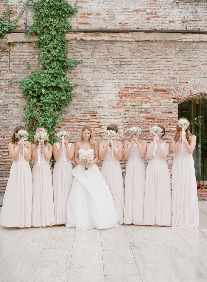 The bride was wearing a strapless dress with wrap skirt detailing and her bridesmaids were rocking blush gowns