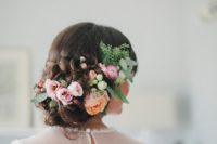 02 beautiful curly updo with pastel flowers and greenery tucked in