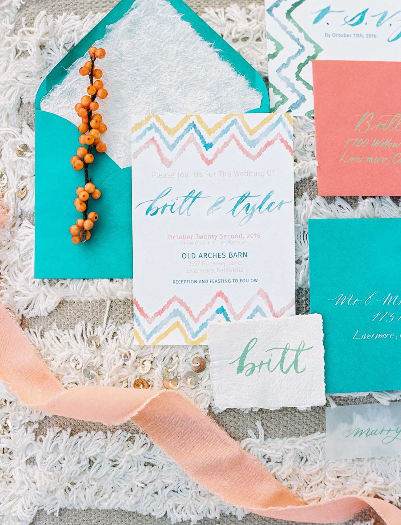 The adorable wedding stationary set was done in turquoise, orange and blue