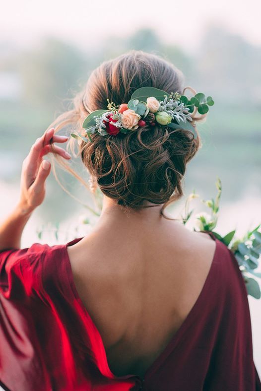 chic curly updo with fresh greenery and flowers