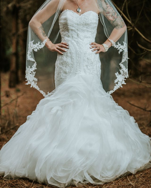 The bride was wearing a gorgeous strapless wedding dress with beading and a mermaid silhouette
