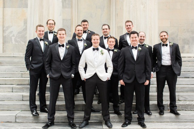 The groomsmen were wearign black tuxedos, and the groom was rocking a white one