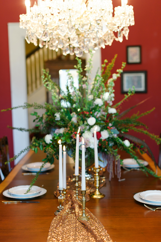 The tablescape was done with a sparkling gold table runner, a lush oversized floral centerpiece and candles