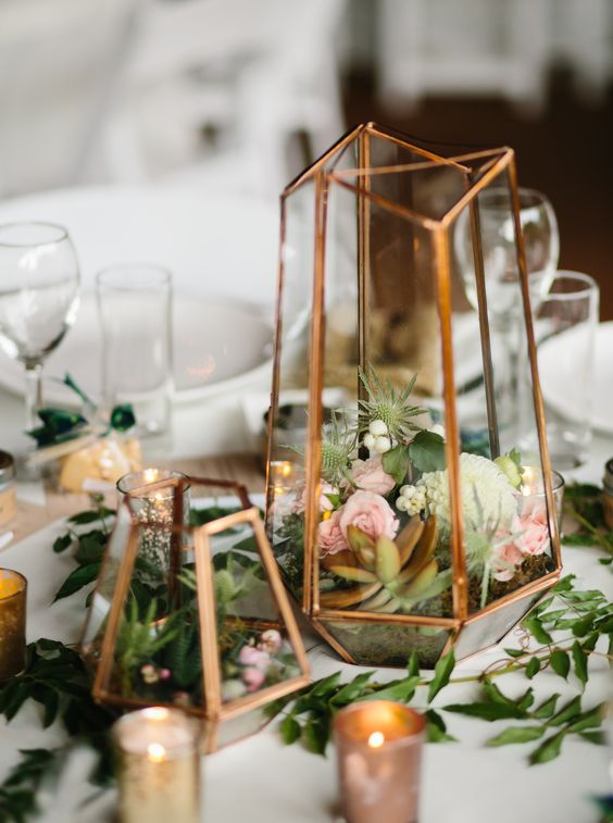a terrarium centerpiece in mixed metallics (gold, rose gold, and silver) with small floral and succulents