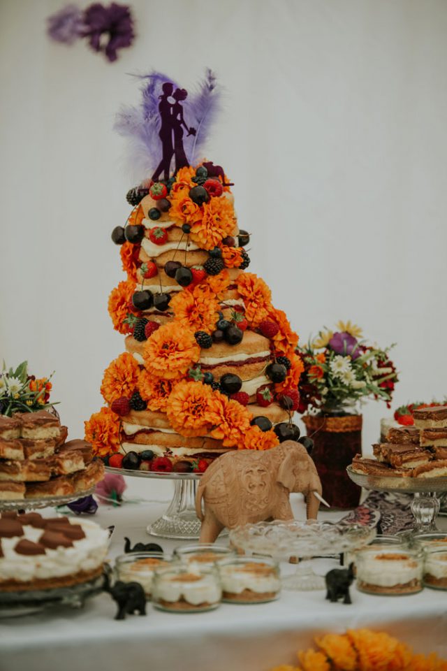 The wedding cake was a bold naked one, with orange flowers, cherries and strawberries