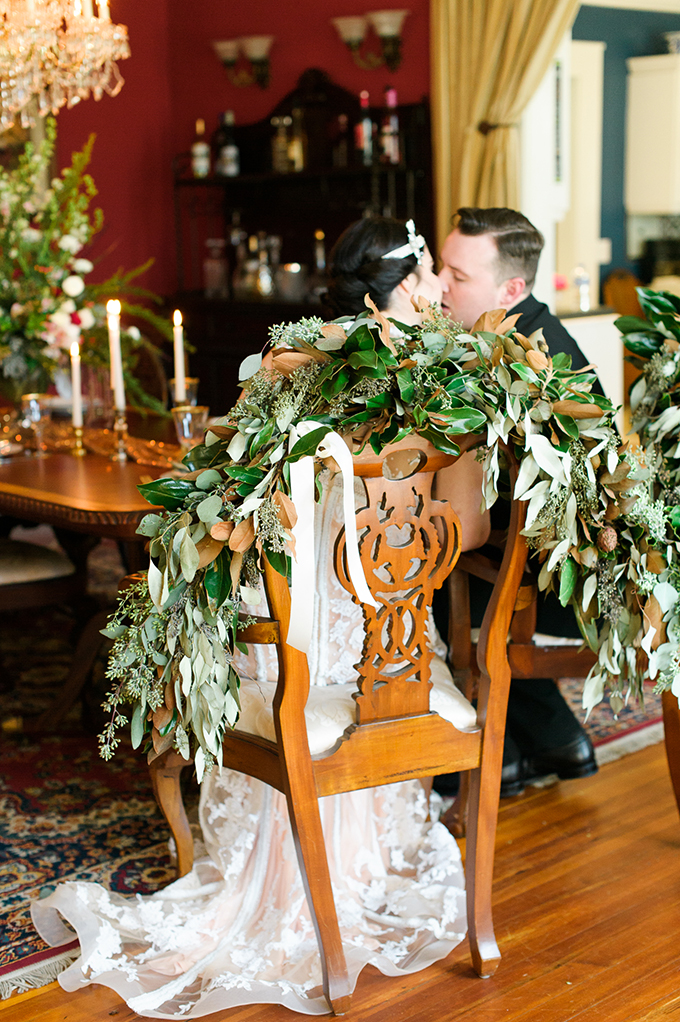 The couple's chairs were decorated with leaves in a lush and bold way