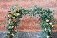 06 lush flower and greenery wedding arch indoors can create a feeling of being in the garden
