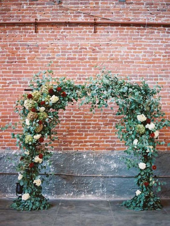 lush flower and greenery wedding arch indoors can create a feeling of being in the garden