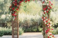 07 The wedding arch was a wicker one, with lush bold flowers