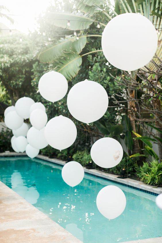white balloons will give your pool a dreamy and airy look
