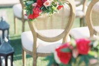 09 The chairs were decorated with floral posies for a bold eye-catchy look