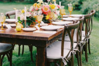 09 The table was laid with the same bold flowers, colorful glasses, candles and even fruit for decor