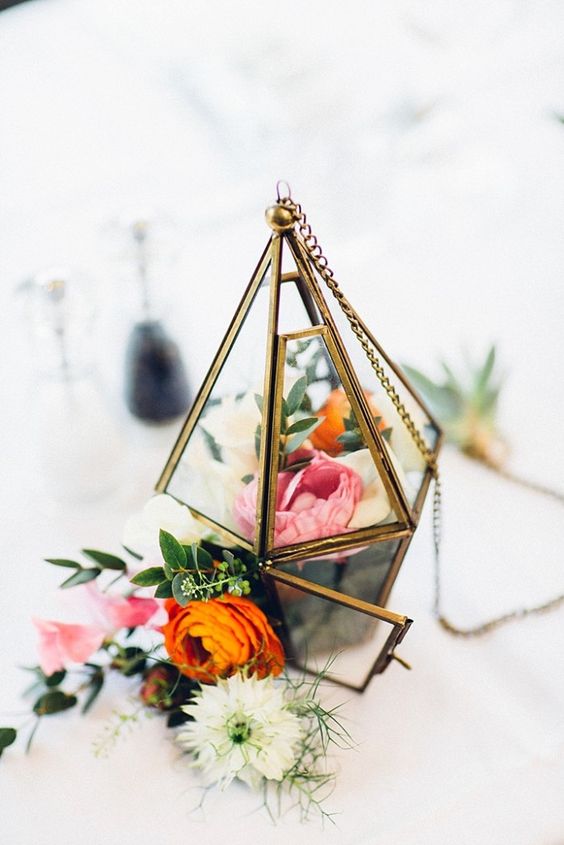 beautiful flower-filled terrarium with a chain to hang if you want
