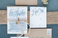 11 kraft paper envelopes, light blue watercolor wedding stationary with driftwood attached