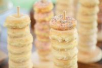 11 mini donuts on stands to enjoy
