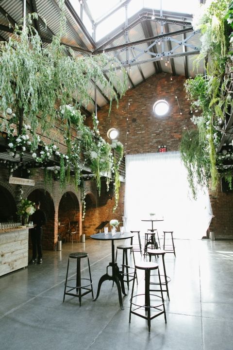 hang greenery and flowers over the whole reception to trun even an industrial space into a garden