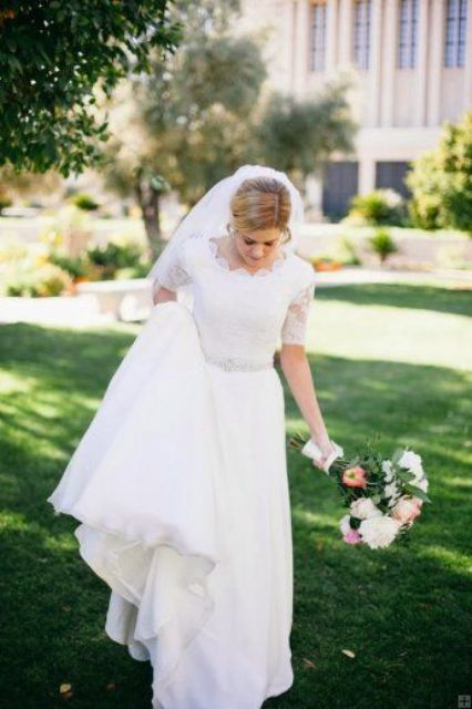 refined lace wedding dress with short sleeves and an embellished belt