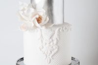 13 lace and silver tier wedding cake with an edible flower