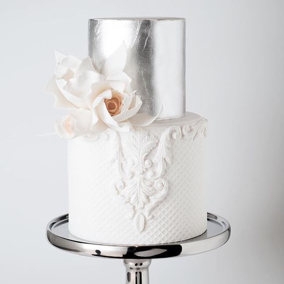 lace and silver tier wedding cake with an edible flower