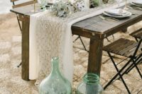 14 calm wedding tablescape with air plants, sea grass, fishing net and green glass bottles