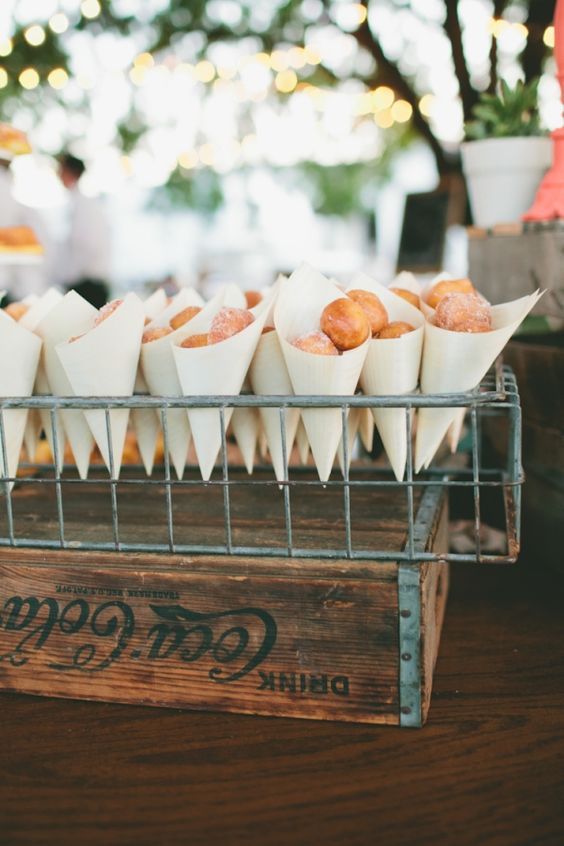 display donuts in paper cones and in wire stands for a rustic wedding