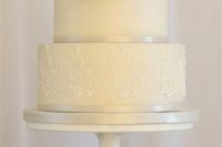 14 ivory lace wedding cake with a top metallic tier and a white rose