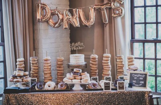 glam donut snack bar with a sequin tablecloth and balloon letters banner