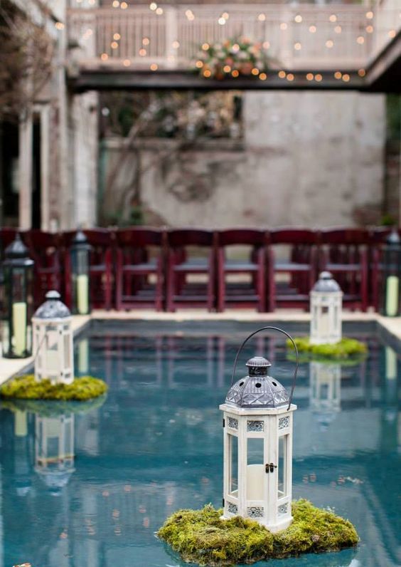 moss and lanterns floating in the pool
