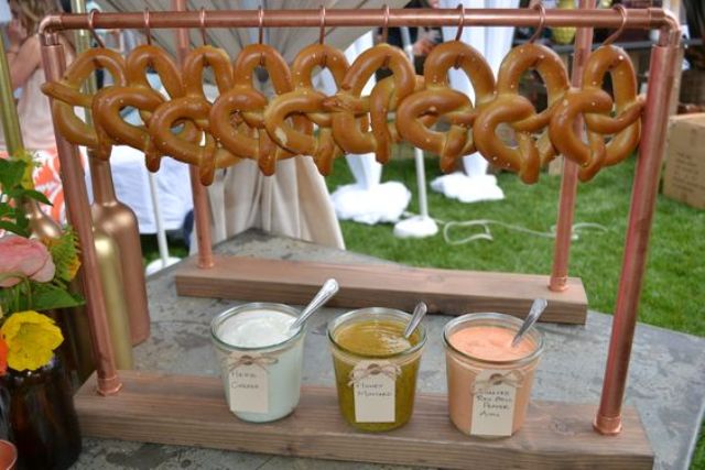 pretzel station with hanging pretzels and dipping sauces