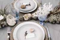 17 grey tablescape with stones, air plants, corals and blue glasses inspired by the ocean
