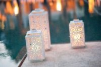 17 laser cut candle lanterns to light up the pool
